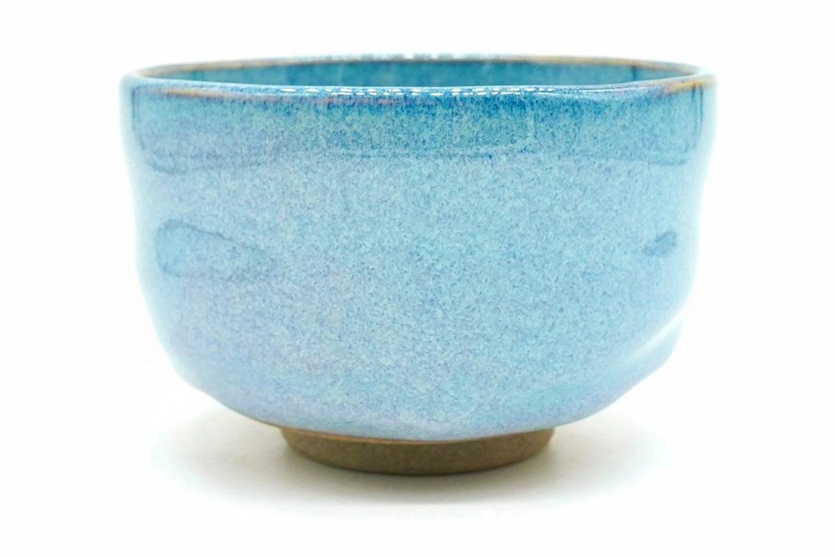 Sorairo Yunomi, a bowl-shaped teacup in a softly mottled pale sky-blue glaze with a bare brown foot