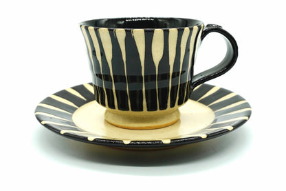 Sumi Yunomi, a Mino ware cup and saucer with brushed black stripes over cream and a black handle, front view