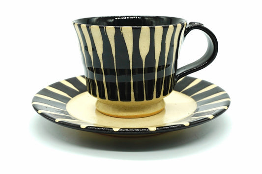 Sumi Yunomi, a Mino ware cup and saucer with brushed black stripes over cream and a black handle, front view