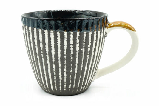 Tōhō Yunomi, a Mino ware mug with cream stripes on dark clay and a glossy blue-black rim, front view
