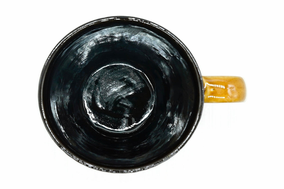 Tōhō Yunomi from above, the glossy black inside and amber handle top