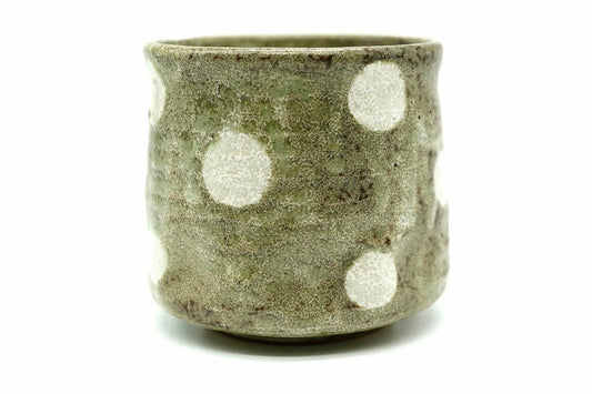 Yayoi Yunomi, a rough moss-green Mino ware teacup with large white dots, front view